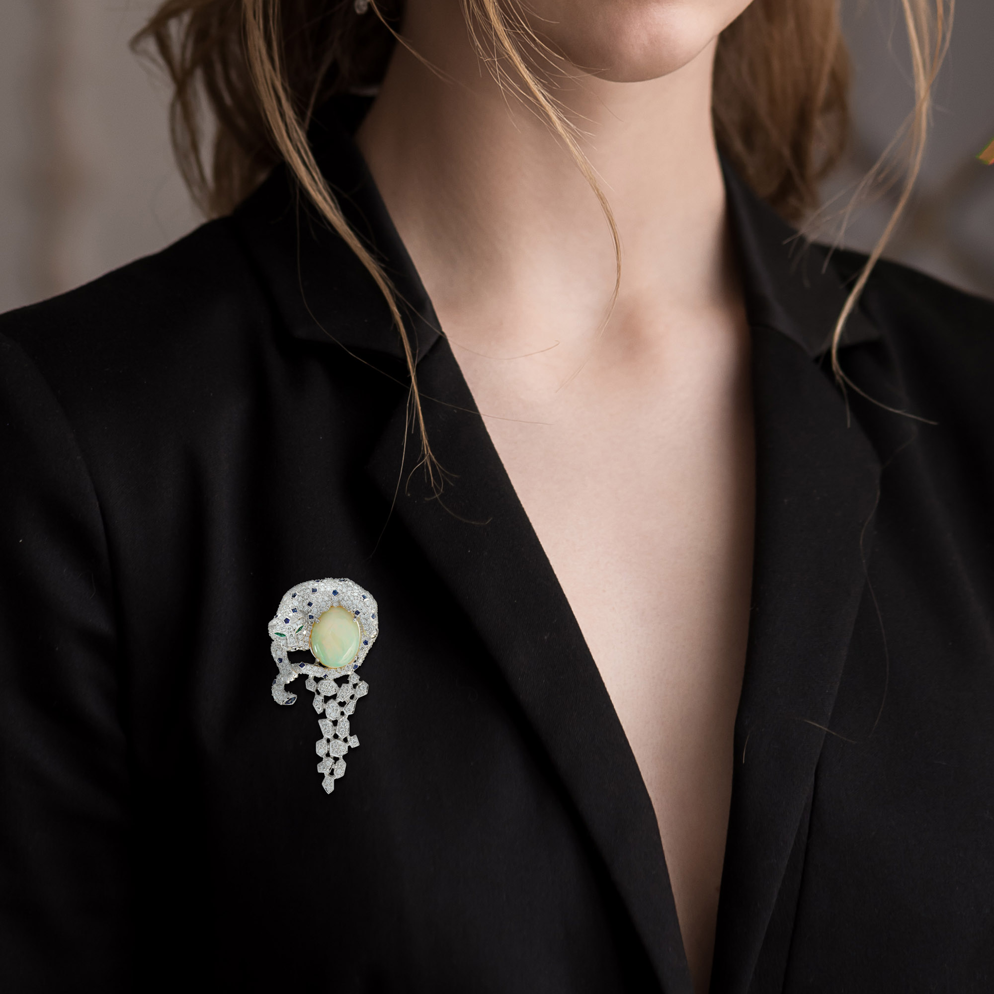 Portrait of a beautiful girl with hairstyle and make-up in a black jacket.