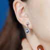diamond-sapphire-drop-earrings-on-body-distant-side Diamond and Sapphire Drop Earrings Side Distant