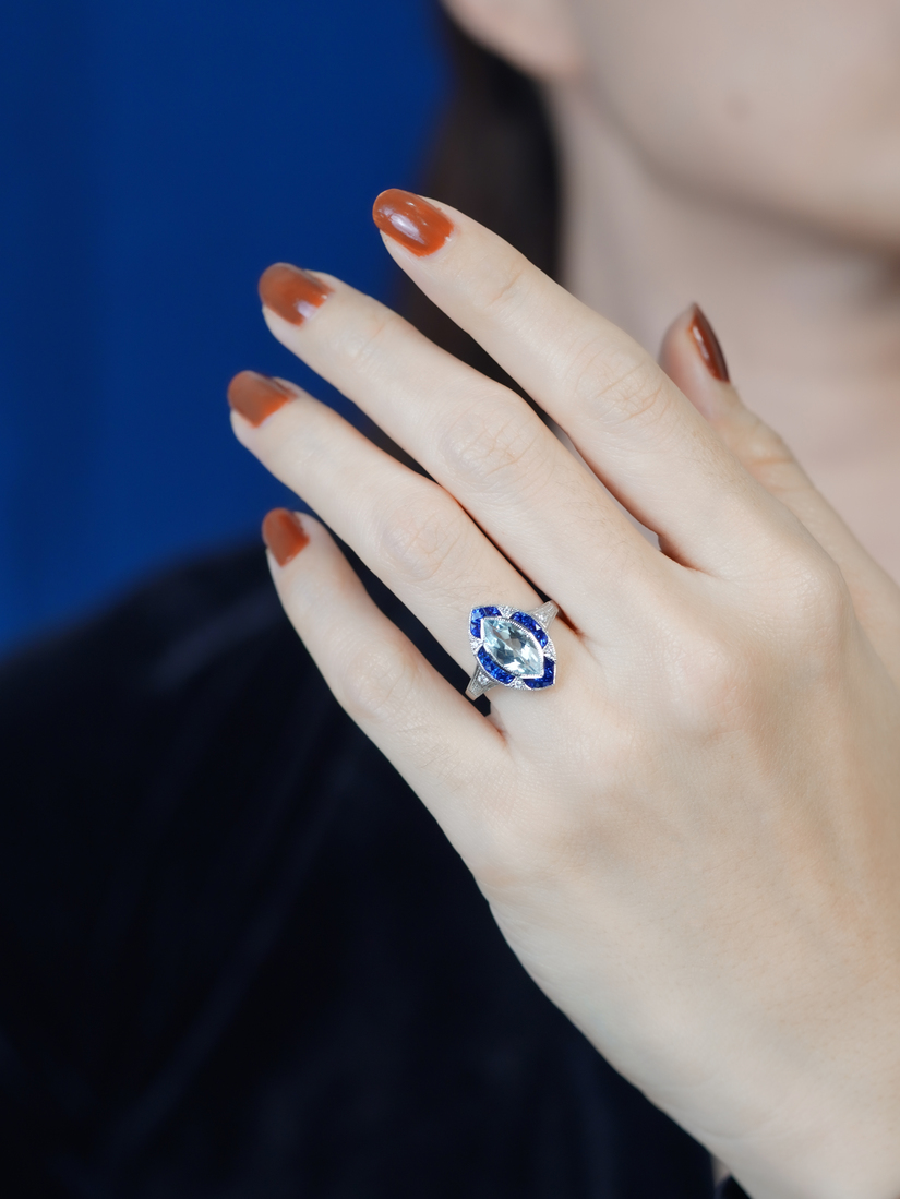 marquise-aquamarine-and-sapphire-engagement-ring-on-body-front-distant Marquise Aquamarine Sapphire and Diamond Engagement Ring on Body Distant