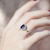 sapphire-and-diamond-engagement-ring-on-body-distant-side Sapphire and Diamond Engagement Ring on Body Distant Side