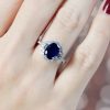 sapphire-and-diamond-engagement-ring-on-body-near-front Sapphire and Diamond Engagement Ring on Body Near Front