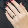 ceylon-sapphire-diamond-halo-engagement-ring-18k-yellow-gold-on-body-front-near Ceylon Sapphire Diamond Halo Engagement Ring on Body Front Near