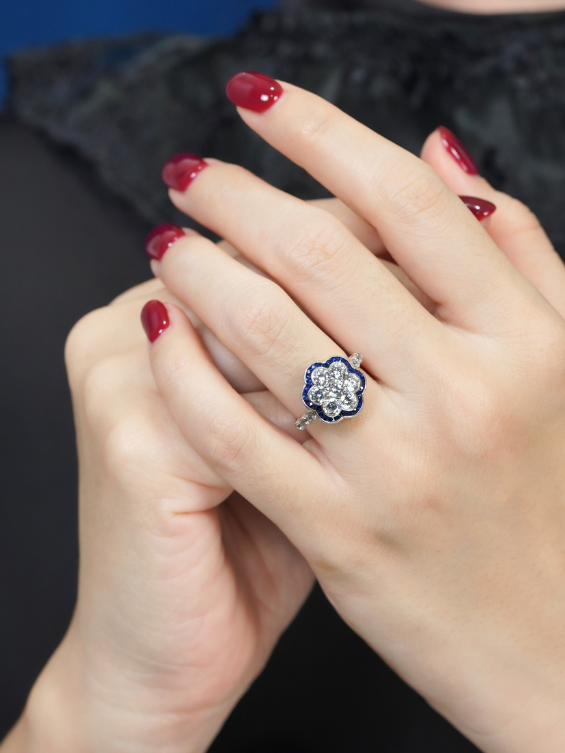 diamond-cluster-blue-sapphire-ring-art-deco-18k-white-gold-on-body-front-near Diamond Cluster and Blue Sapphire Art Deco Style Ring