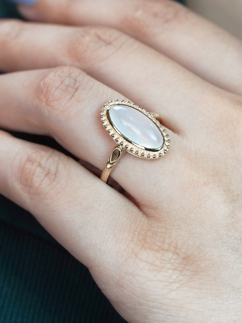 oval-moonstone-solitaire-ring-art-deco-style-9k-gold-on-body-front-near Oval Moonstone Art Deco Style Ring on Body Front Near