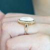 oval-moonstone-solitaire-ring-art-deco-style-9k-gold-on-body-side-near Oval Moonstone Art Deco Style Ring on Body Side Near