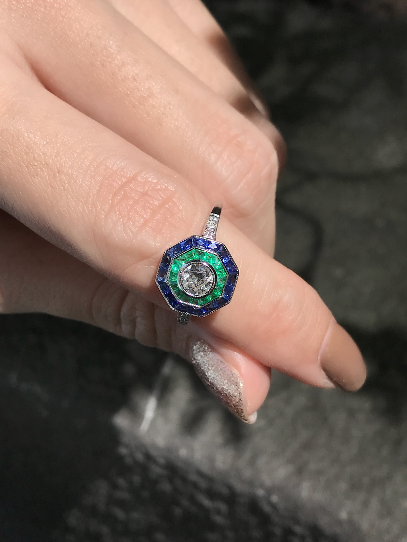 round-diamond-emerald-sapphire-target-ring-art-deco-style-18k-gold-beauty-shot-front Diamond Emerald Sapphire Art Deco Style Ring on Body Near